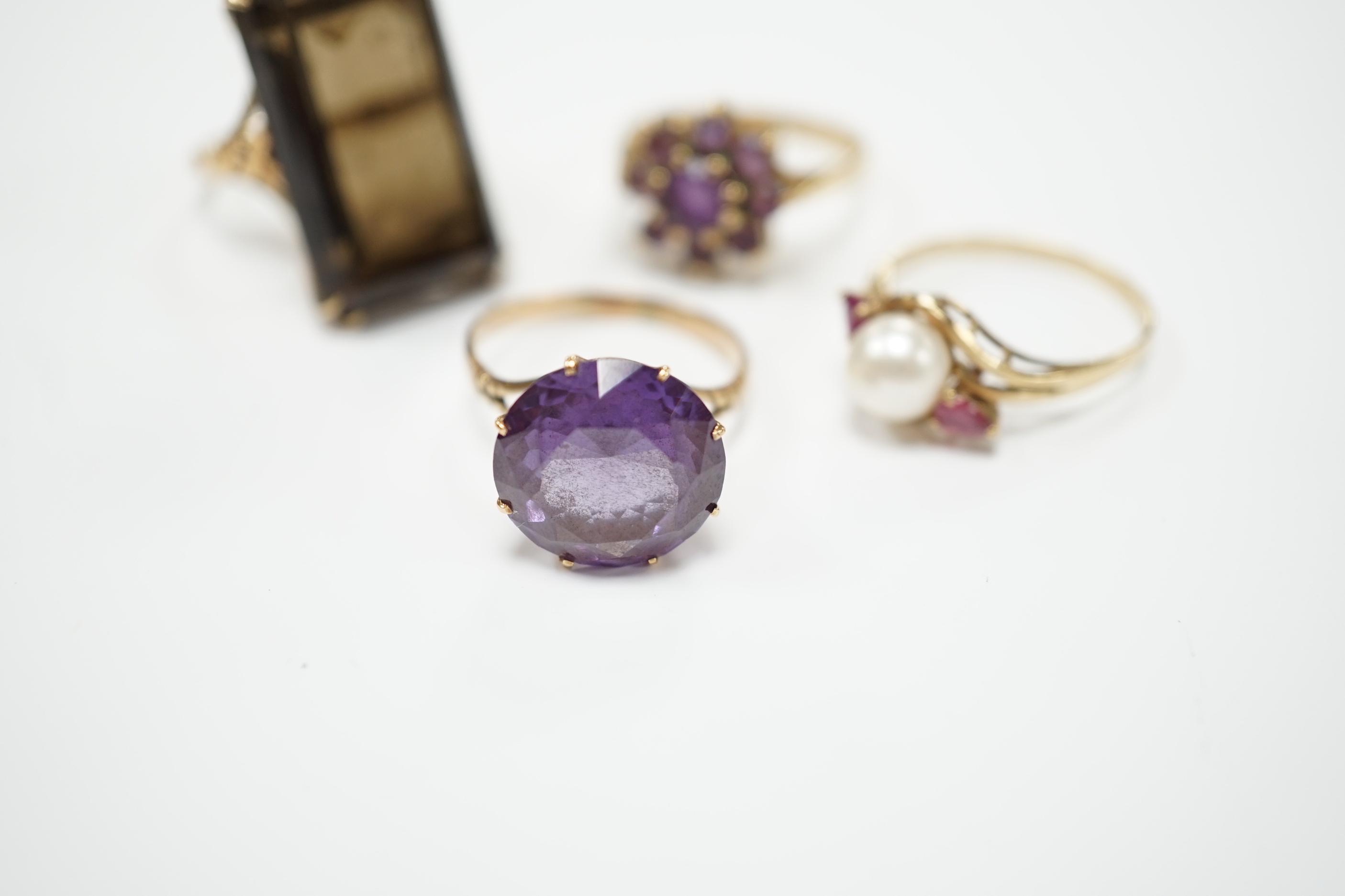 Two modern 9ct gold and gem set dress rings and two other yellow metal and gem set dress rings, gross weight 19.9 grams.